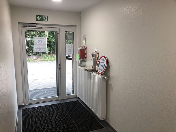 Wandmontierter AED direkt hinter der Eingangstür links an der Wand